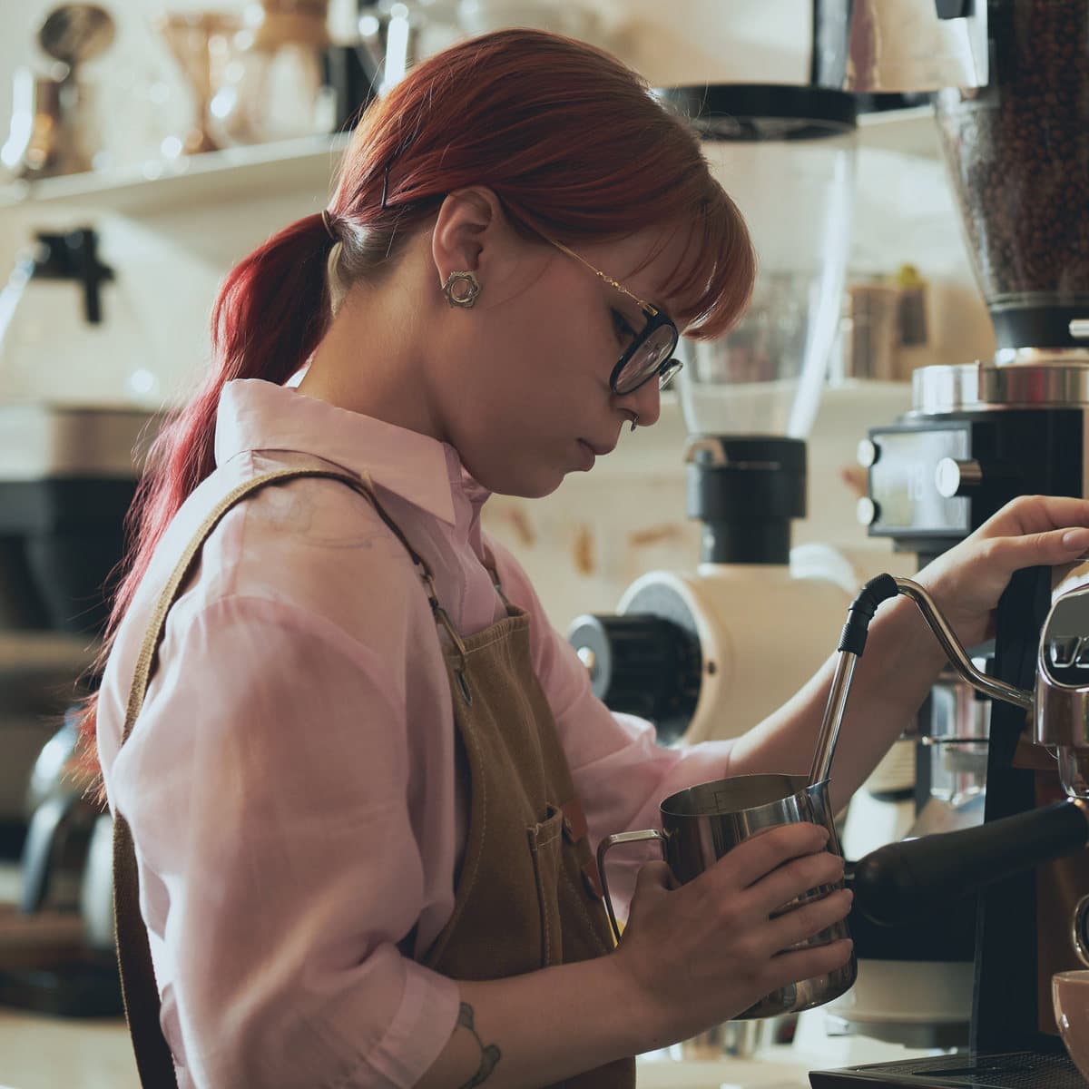 A barista making coffee behind the counter