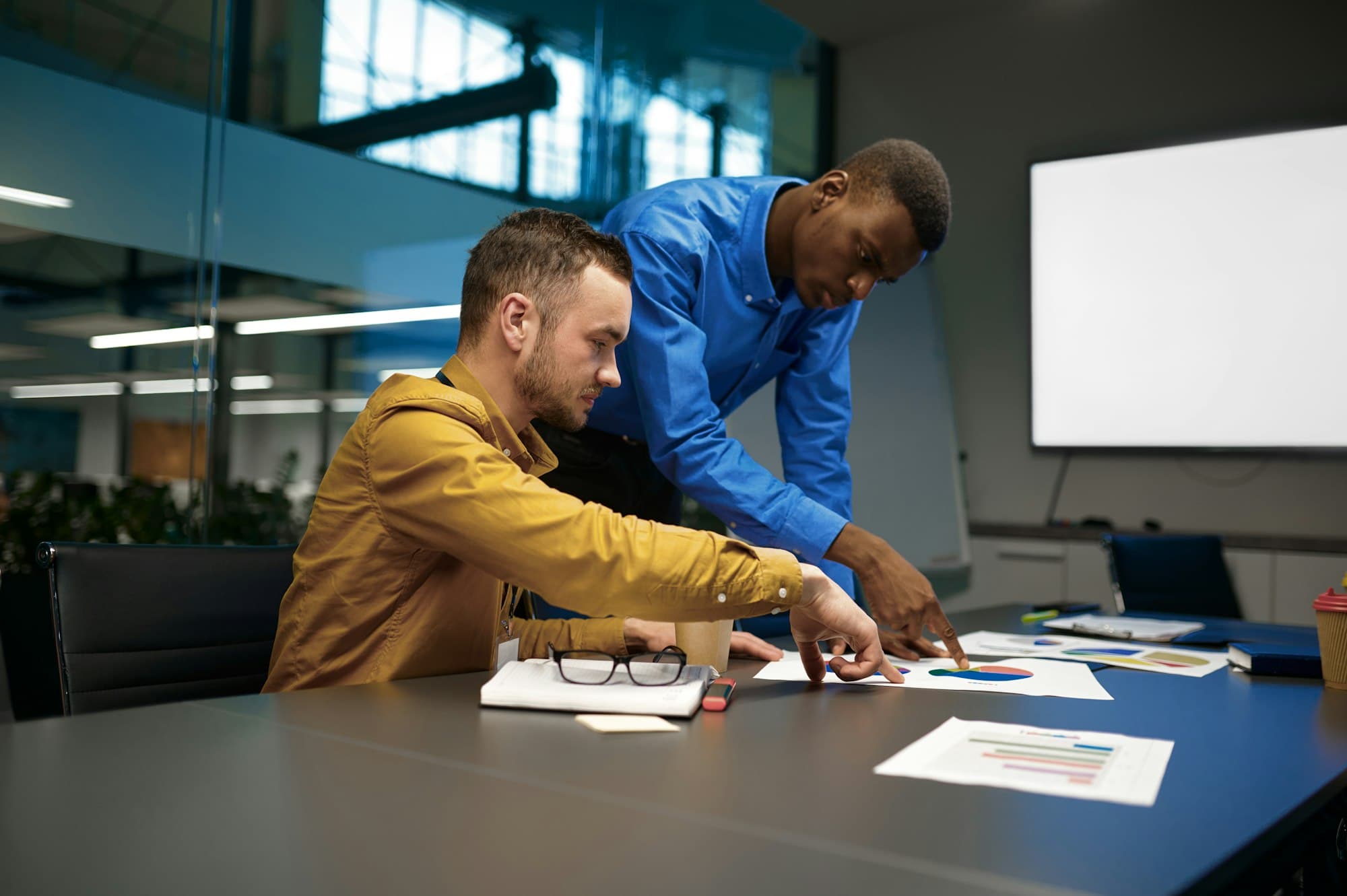 A team talking through a problem around a desk in an office