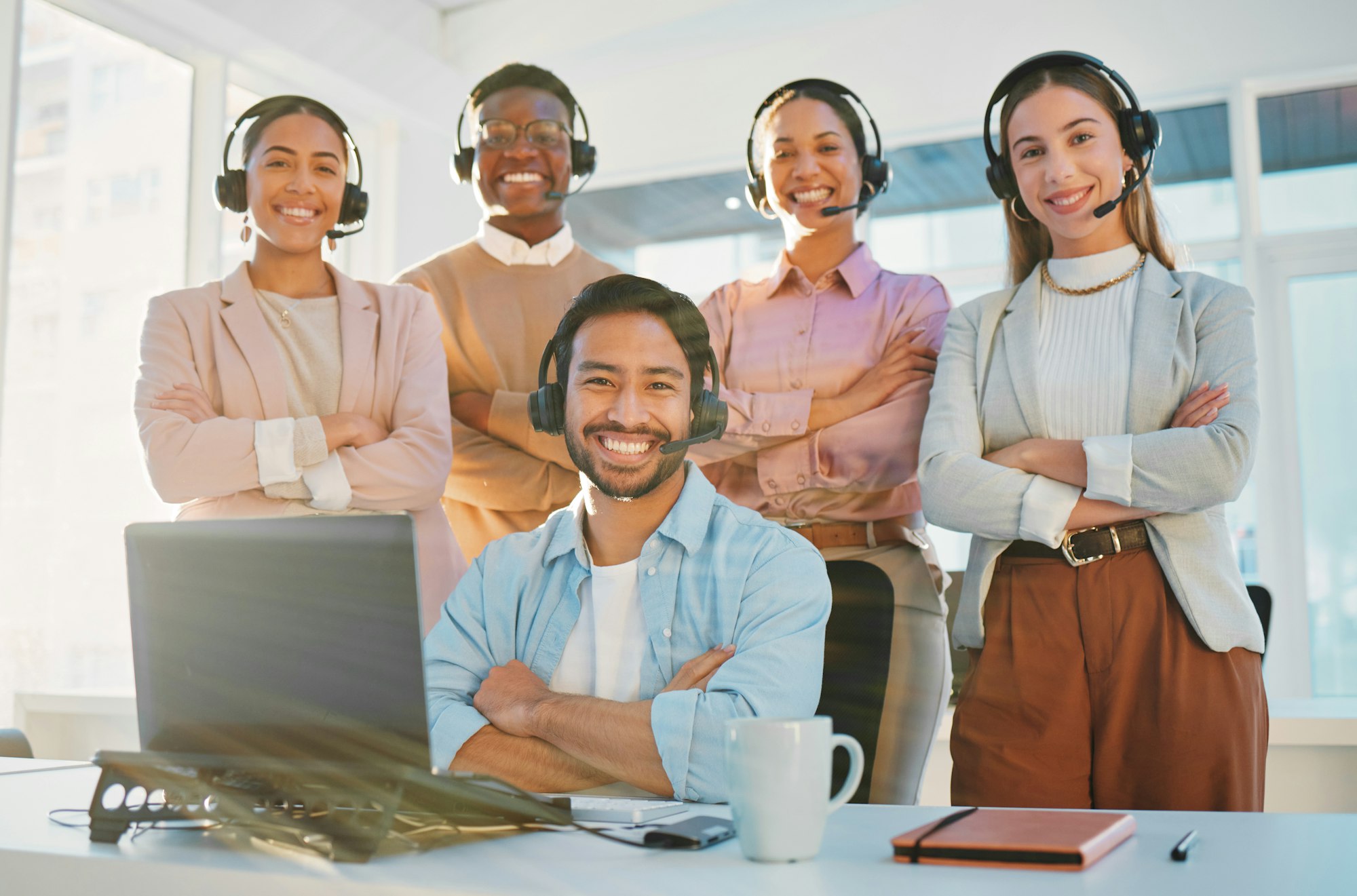 Team, portrait and call center consultant group with arms crossed, contact us with headphones and h